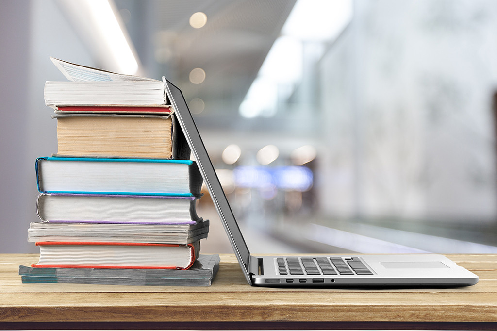 Laptop stacked against books